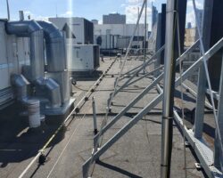 Elektryk instaluje jednostkę klimatyzacyjną na dachu.
